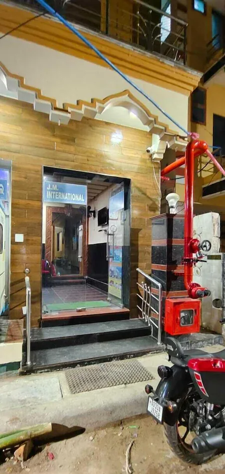 Wooden-panelled entrance with the J.M. International sign