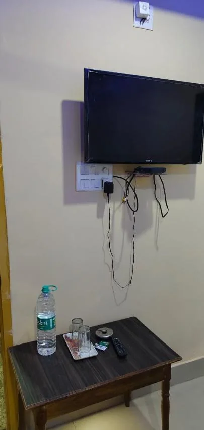 Wall-mounted TV with a table and drinking water