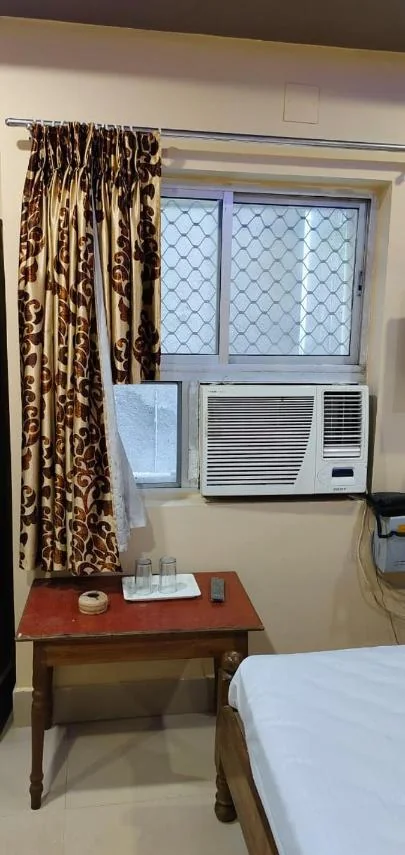 Table with water glasses by the window and air conditioner