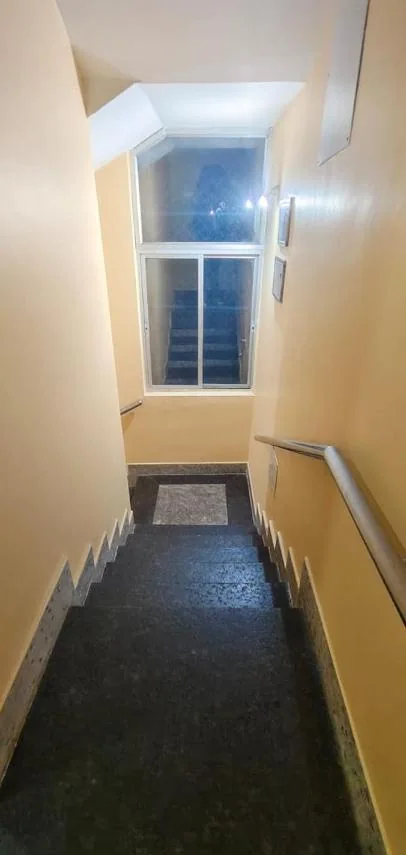Staircase with granite steps and a steel handrail